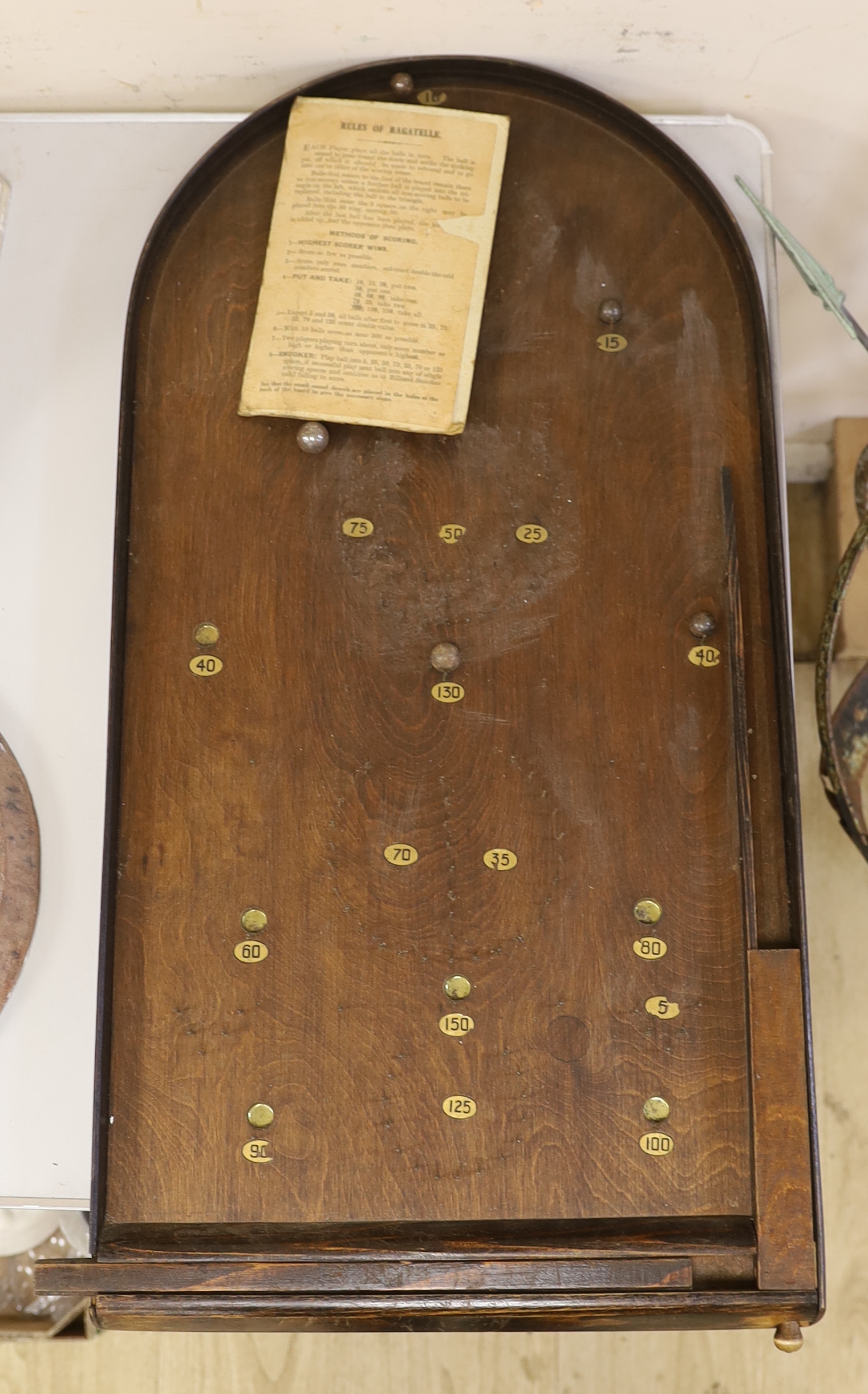 A bagatelle board with balls and instructions